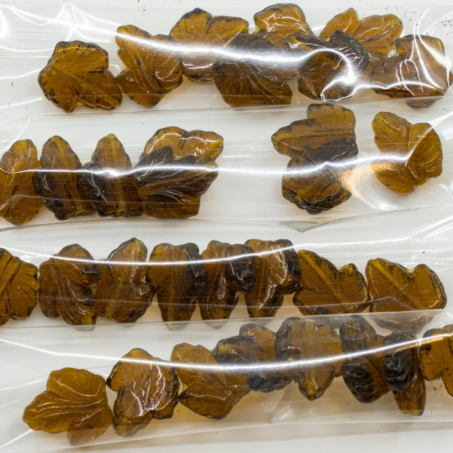OUTLET 10 grams Grape Leaf Beads, 16 x 14 mm, Transparent Brown (10230), Glass, Czech Republic
