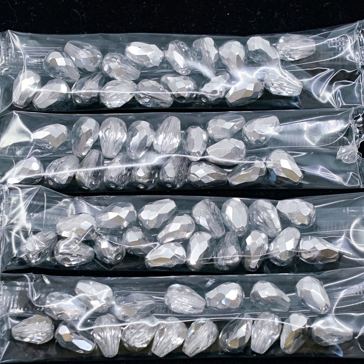 OUTLET 10 grams Pear Teardrop Beads Faceted Fire Polished, 10 x 7 mm, Crystal Crystal Silver Half Coating (00030-27001), Glass, Czech Republic